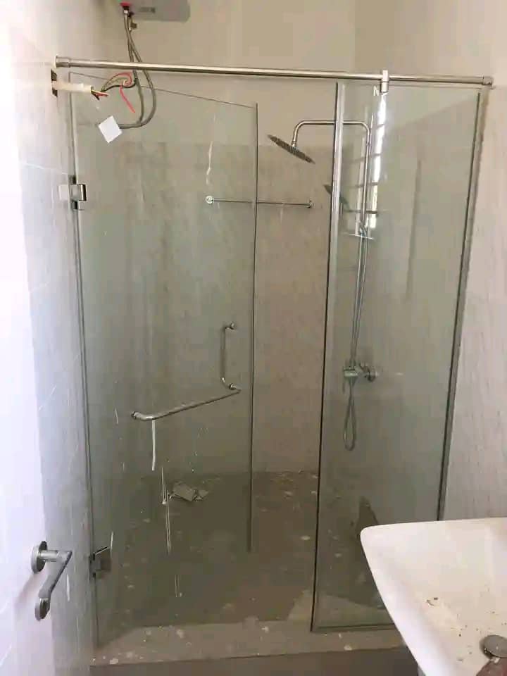 Luxurious contemporary bathroom featuring glass shower partition